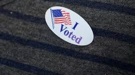grey shirt with I voted sticker.